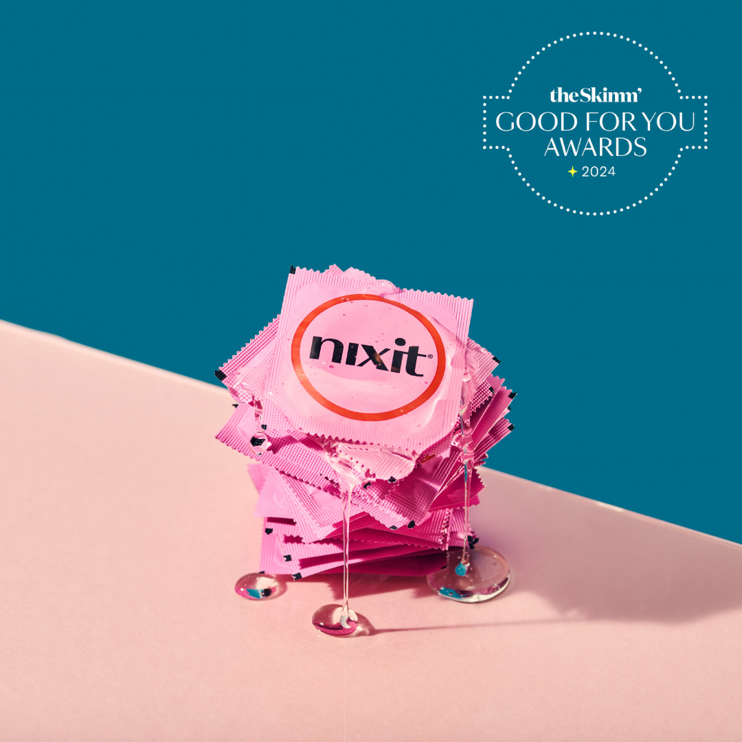 a stack of nixit condoms in their wrappers with lubricant dripping off them and pooling below them, with the wording 'theSkimm' GOOD FOR YOUR AWARDS 2204'