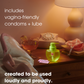 a bedside table with a phone off the hook, drink, nixit menstrual cup on a pile of books, nixit water-based lubricant and two condoms with the wording 'includes vagina-friendly condoms + lube' and 'created to be used loudly and proudly.'