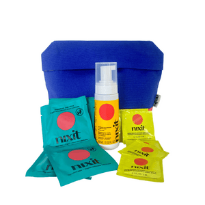 An image of the nixit travel essentials on a white background - travel essentials cotton bag, 5 nixit menstrual cup wipes, a travel size menstrual cup wash and 10 personal lubricant sachets